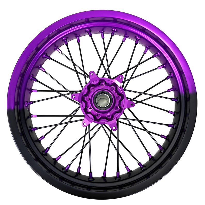 May include: A motorcycle wheel with a vibrant purple rim that fades to black. The wheel features black spokes and a purple hub, creating a striking contrast. The design is symmetrical and detailed, suitable for custom motorcycle builds.