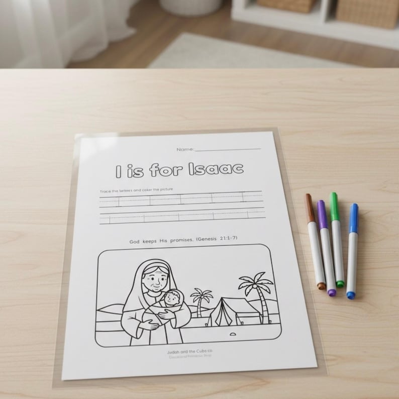 May include: A white worksheet with the text "I is for Isaac" and a black and white illustration of a woman holding a baby. Four colored markers are next to the worksheet.