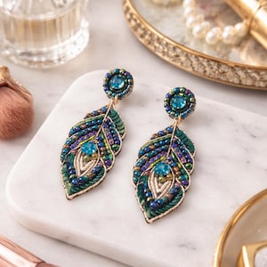 May include: A set of three ceramic mugs with a speckled, matte finish. The mugs are in shades of cream, light gray, and dark gray. Each mug has a simple, modern design and a rounded handle. The mugs are stacked on top of each other.