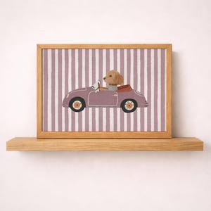 May include: A framed print featuring a cartoon dog driving a vintage purple car. The dog is wearing a collar and driving gloves. The background has vertical stripes in shades of purple and white. The frame is made of wood.