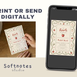 May include: A rectangular baby shower invitation card featuring a cream background, a decorative green scalloped border, and red apple illustrations. The text reads The Apple of Our Eye, Mabel Hart, and event details. A smartphone displays the same design.
