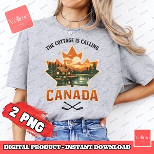 May include: A grey t-shirt featuring the text "THE COTTAGE IS CALLING CANADA" and a graphic of a cabin scene within a maple leaf. Crossed hockey sticks are below the text. The words "2 PNG" are also visible.