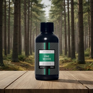 May include: A black bottle of "Pine Woods" reed diffuser fragrance oil, with a label that reads "Aronica". The bottle is 4.05 fl oz (120mL). The background is a forest scene with tall trees.