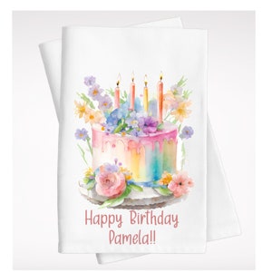 May include: A watercolor illustration of a pink and yellow birthday cake with rainbow frosting and candles. The cake is decorated with flowers and the text "Happy Birthday Pamela!" is written below the cake.