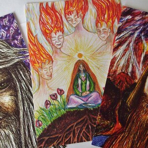 May include: Three illustrated cards with a fantasy theme. The first card features a bearded man with long white hair. The second card shows a woman with long red hair sitting in a forest with a sun and five figures with flames behind her. The third card shows a man with a beard and a helmet with his eyes closed.