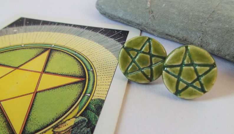 May include: A pair of green ceramic earrings with a five-pointed star design.