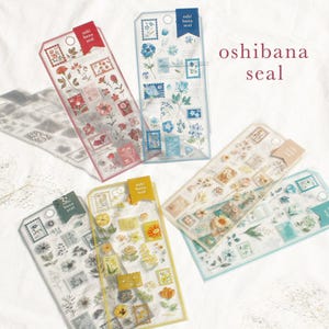 May include: Transparent sticker sheets with floral designs, resembling postage stamps. Each sheet has a coloured tag with the text "oshi bana seal". The text "oshibana seal" is also visible.