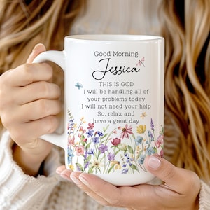 May include: White ceramic mug with a floral design and the text "Good Morning Jessica". The mug features a handle and is decorated with colorful flowers and butterflies. The text on the mug reads "THIS IS GOD I will be handling all of your problems today I will not need your help So, relax and have a great day."