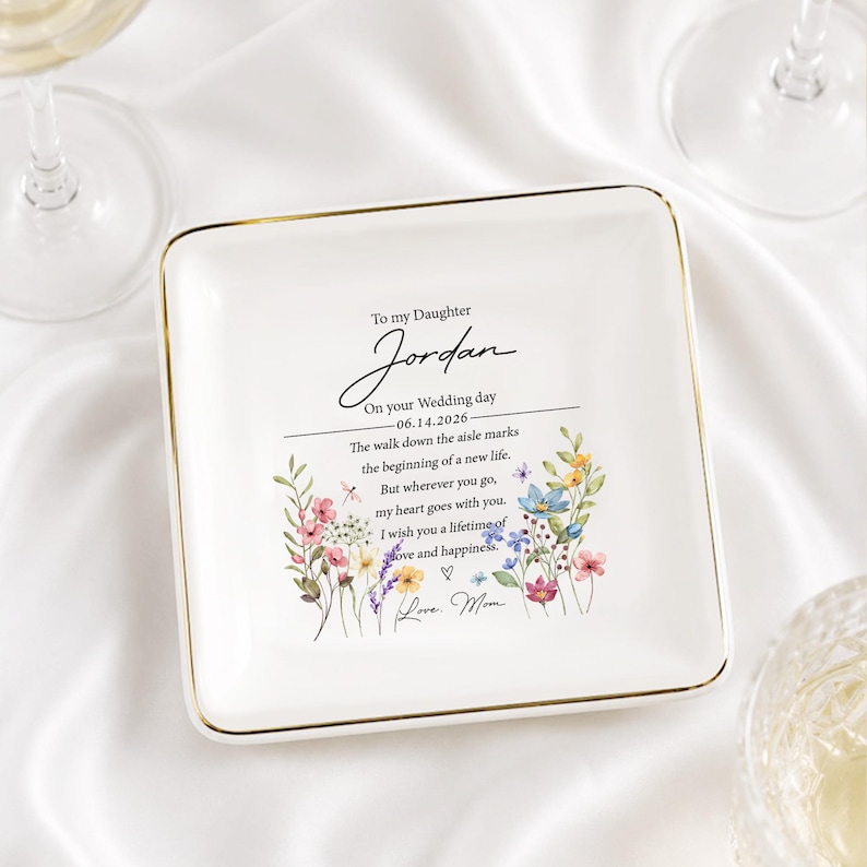 May include: A square white ceramic trinket dish with a gold-trimmed edge. The center features a floral design and text that reads: To my Daughter Jordan On your Wedding day 06.14.2026 The walk down the aisle marks the beginning of a new life.