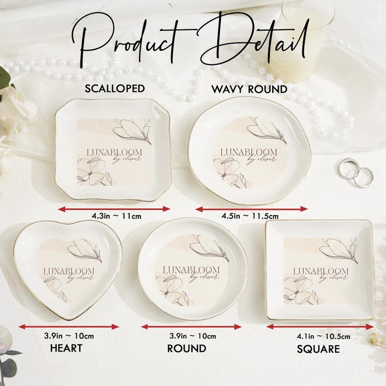 May include: Five white ceramic trinket dishes in scalloped, wavy round, heart, round, and square shapes. Each dish features a floral line art graphic and the text LUNABLOOM by oliver. Dimensions range from 3.9 inches to 4.5 inches in width.