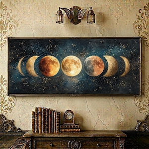 May include: A rectangular wall art piece featuring a horizontal sequence of moon phases against a dark blue, starry night sky. The painting displays various lunar stages from crescent to full moon in shades of gold, ochre, and grey, framed in a dark border.