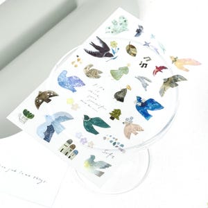 May include: A sheet of decorative stickers with watercolour illustrations of birds, leaves, and floral elements in various colours. The stickers include text that reads "Life is short, love yourself, more..." and "Safe."