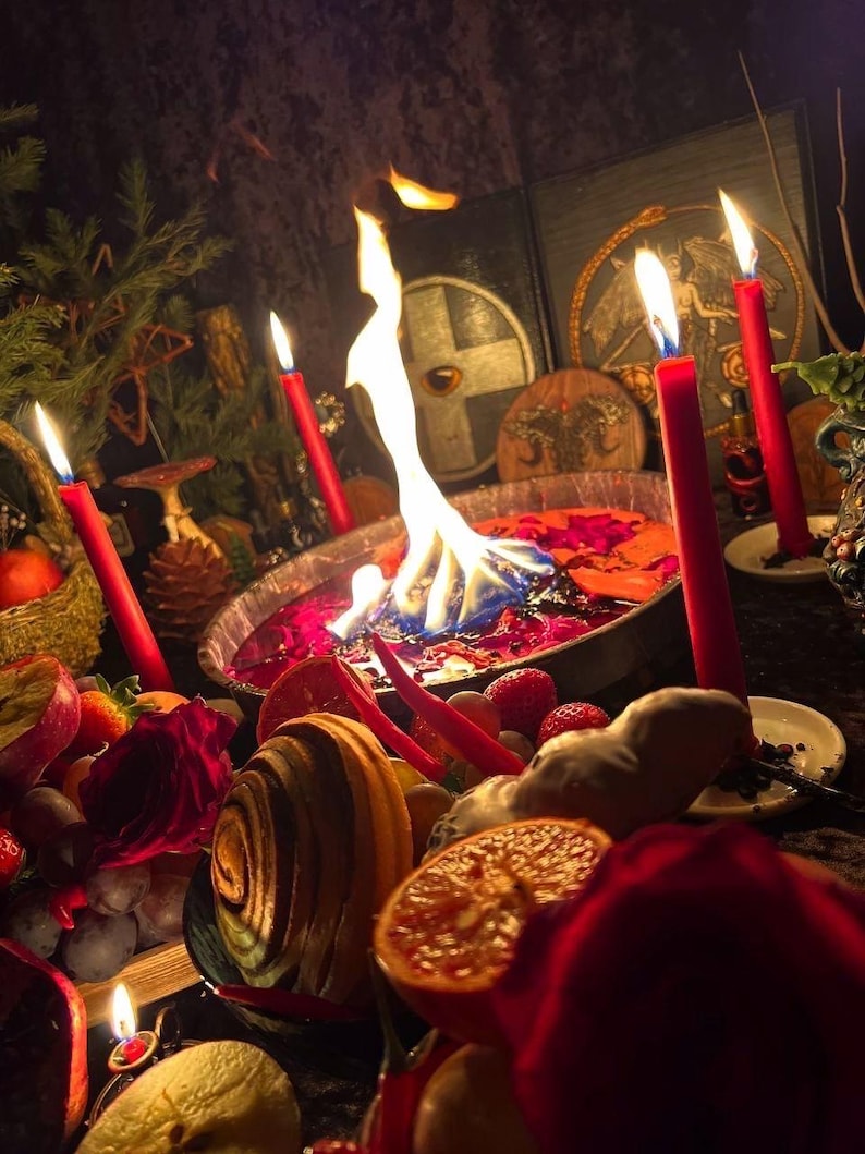 May include: A mystical scene featuring a central bowl with flames, surrounded by red candles, fruits, and other ritualistic items. The bowl contains colorful liquids, and the scene is dimly lit, creating a mysterious atmosphere.