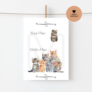 May include: A white print featuring watercolor illustrations of kittens. The text reads "Your Plan" and "God's Plan". A digital download tag is in the upper right corner. The print is hanging from a wooden clothespin.