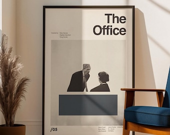May include: A framed poster with the text "The Office" in a minimalist design. The poster features a black and white image of two people and a dark blue rectangle. The poster is displayed in a well-lit room with a blue chair and a decorative plant.