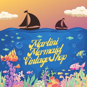 May include: A digital illustration featuring a sunset sky with two sailboats above a deep blue ocean. The underwater scene displays colourful coral reefs, various tropical fish, and bubbles. The text Martini Mermaid Vintage Shop is centred.