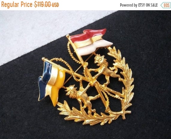 Vintage collectible crest brooch, dragon flag pin