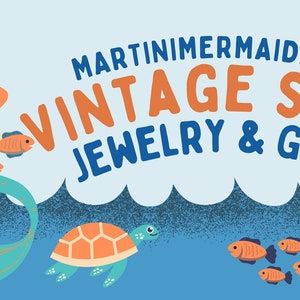 May include: A mermaid with long orange hair sits on a turquoise tail with orange fish swimming around her. A sea turtle swims below her. The text "MARTINIMERMAID.COM VINTAGE SHOP JEWELRY & GIFTS" is at the top of the image.