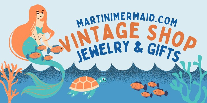 May include: A mermaid with long orange hair sits on a turquoise tail with orange fish swimming around her. A sea turtle swims below her. The text "MARTINIMERMAID.COM VINTAGE SHOP JEWELRY & GIFTS" is at the top of the image.
