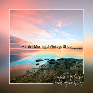 May include: A scenic photograph of a sunrise over the sea with a rocky shoreline in the foreground. The text Martini Mermaid Vintage Shop is centred, and the text Sunrise over the sea makes my heart sing is in the bottom right corner.