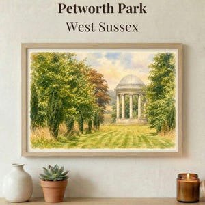 May include: A framed watercolor print of Petworth Park, West Sussex. The artwork depicts a classical gazebo surrounded by trees and a grassy lawn. The print is in a light wooden frame, with a vase, succulent, and candle in the foreground.