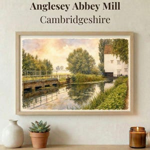 May include: A framed watercolour print of Anglesey Abbey Mill, Cambridgeshire. The artwork shows a tranquil waterscape with a mill, bridge, and verdant foliage. The text "Anglesey Abbey Mill Cambridgeshire" is at the top.