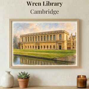 May include: Framed watercolour print of the Wren Library, Cambridge. The artwork shows the library's facade, a canal, and a green lawn. The text "Wren Library Cambridge" is at the top. The frame is made of light-colored wood.