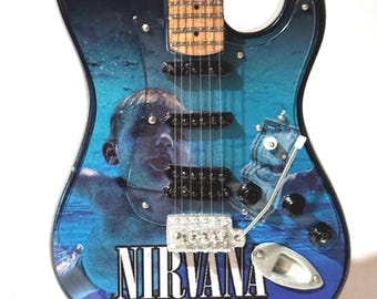 Nirvana 10” tribute guitar with stand.  1:4 scale