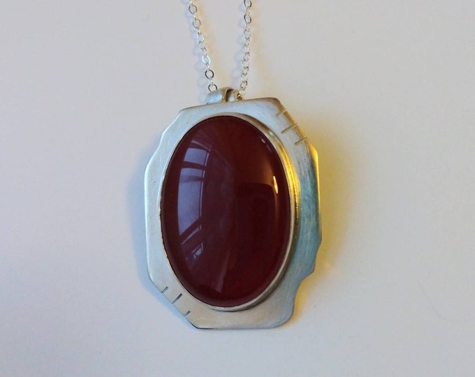Curves and Edges Pendant: Sterling Silver and Red Jade