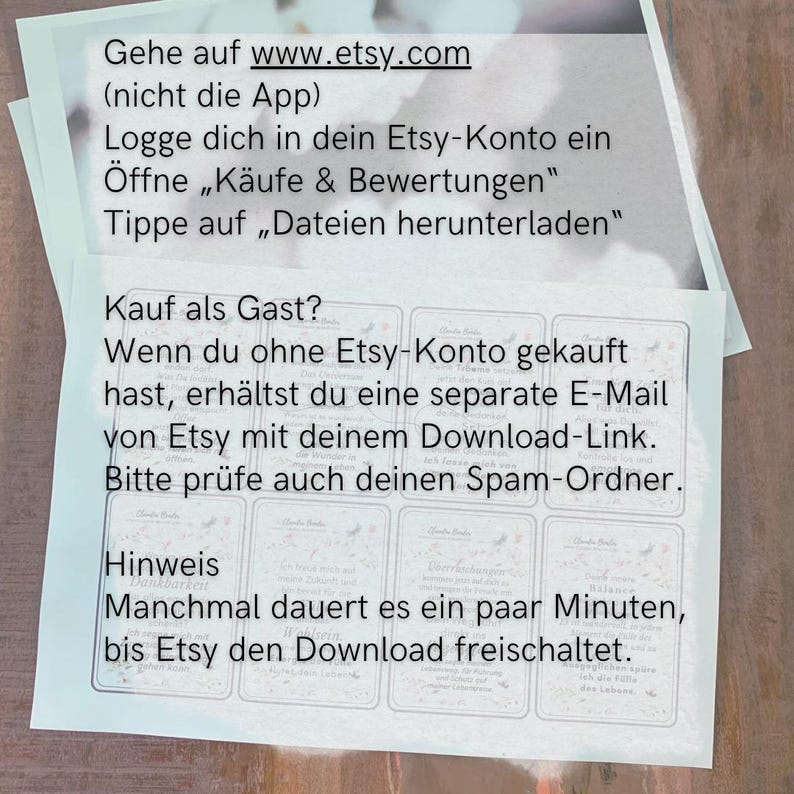 May include: Two white paper sheets with German text, including instructions on how to download files from Etsy. The text includes phrases like "Gehe auf www.etsy.com" and "Dateien herunterladen".