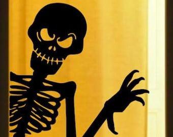 May include: A black skeleton silhouette with an angry expression and reaching hand. The Halloween-themed decoration is set against a yellow background, creating a spooky contrast. The skeleton's rib cage and skull are clearly defined.