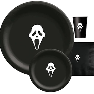 May include: Black party supplies set featuring a white Ghostface mask design. The set includes plates in two sizes, a cup, and a napkin. Perfect for Halloween or horror-themed parties.