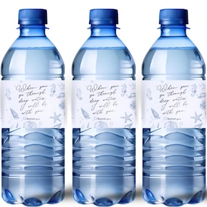 May include: Three clear plastic water bottles with blue caps. Each bottle has a white label with the text "When you go through deep waters, I will be with you." and sea-themed illustrations.