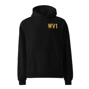 May include: Black hooded sweatshirt with a kangaroo pocket and the gold text "WV1" on the upper chest. The hoodie has long sleeves and a drawstring hood. The garment is made of a soft material.