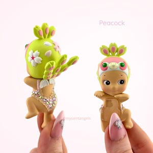 May include: A set of three ceramic mugs with a speckled, matte finish in cream, light grey, and dark grey. Each mug has a simple, minimalist design and a rounded handle.