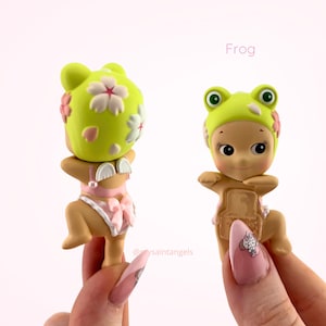 May include: A distressed wooden sign, inscribed with 'Welcome to our home' in white lettering. The sign has a rustic finish, ideal for a porch or hallway, creating a welcoming atmosphere.