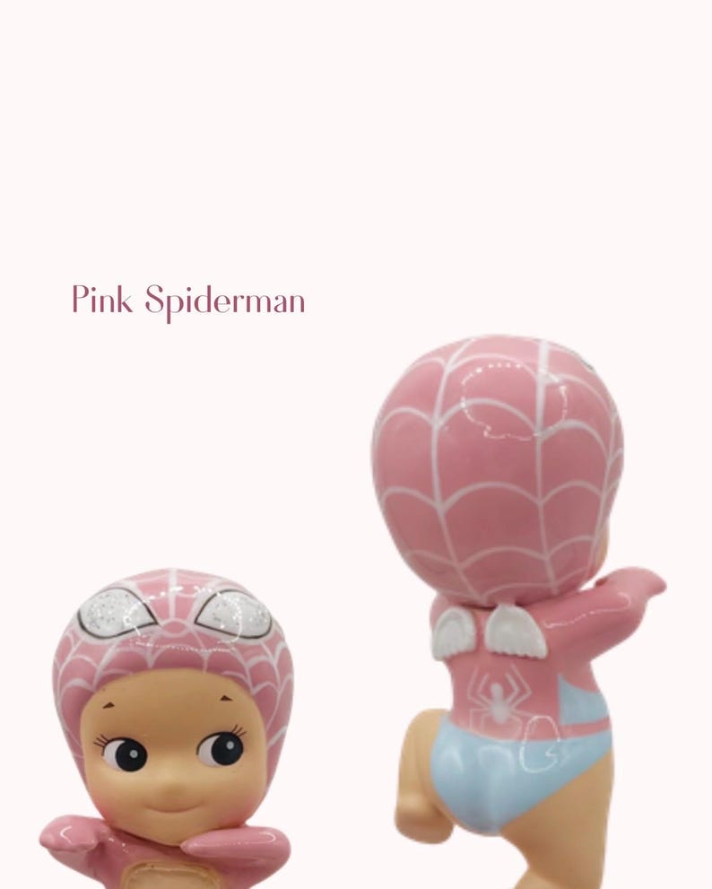 May include: Two pink figurines of a baby dressed as Spiderman. The figurines have a pink head with white web detailing, a light blue diaper, and small white wings. The text "Pink Spiderman" is in the image.