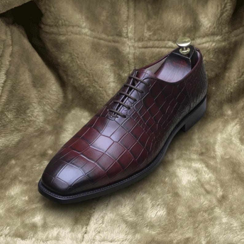 Mens luxury dress shoes in deep burgundy with reptile texture and polished finish