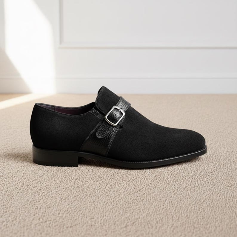 Black leather monk strap shoes for men with single buckle, elegant formal footwear displayed on neutral background