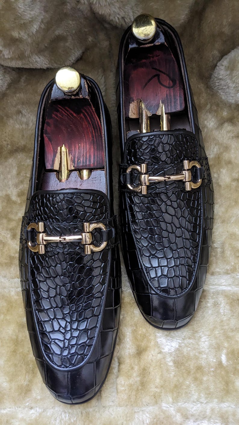 Top view of crocodile pattern loafers highlighting metal horsebit detail