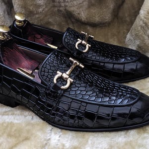 Close up of embossed leather texture on black mens dress loafers
