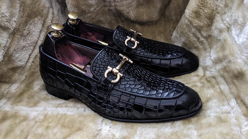 Close up of embossed leather texture on black mens dress loafers