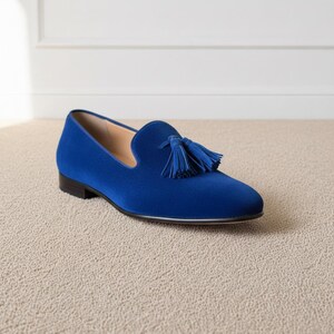 Angled view of mens blue tassel loafers showing soft velvet texture and elegant silhouette
