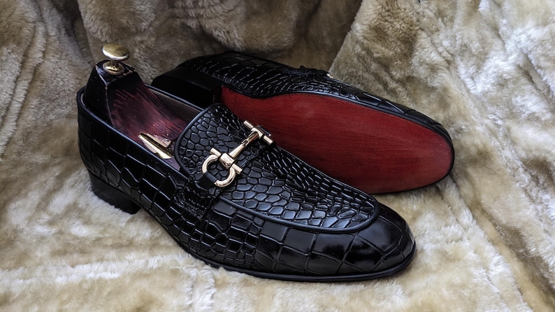 Side view of mens luxury black loafers showing textured leather and sleek silhouette