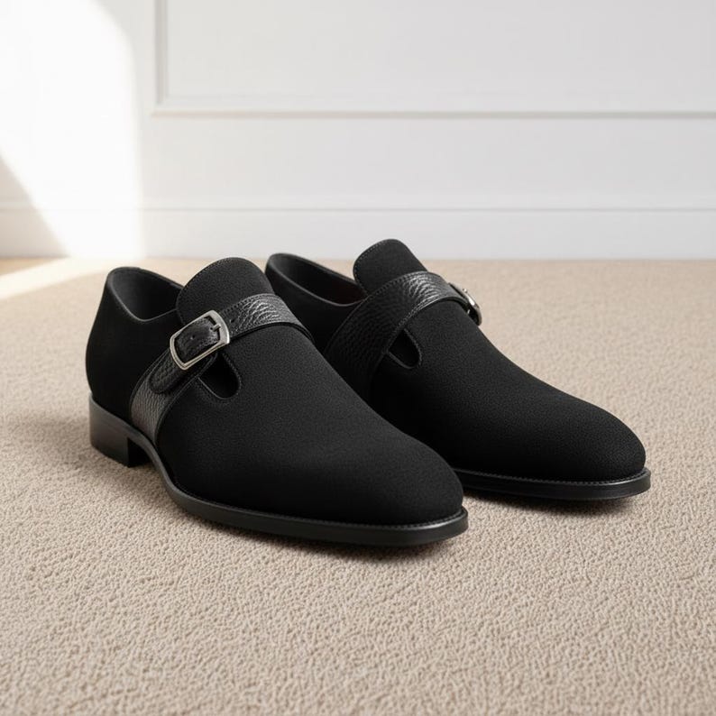 Black leather monk strap shoes for men with single buckle, elegant formal footwear displayed on neutral background