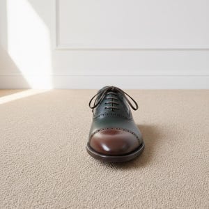 Front perspective of elegant green brown formal brogue shoes with classic lace-up stylin