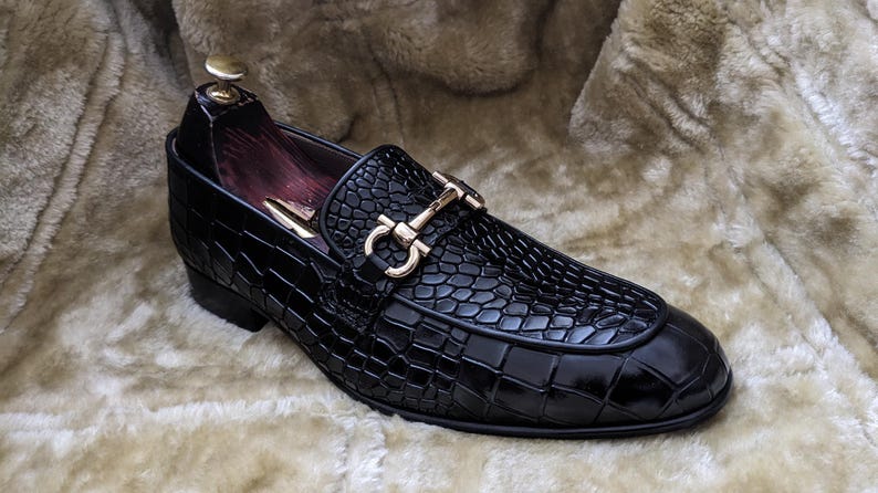 Top view of crocodile pattern loafers highlighting metal horsebit detail
