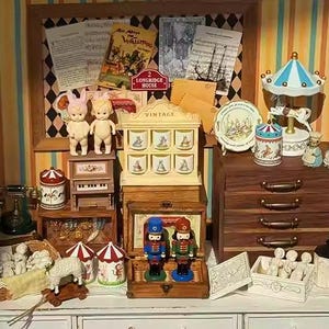 Pode incluir: Uma coleção de brinquedos e itens decorativos vintage, incluindo bonecas, um carrossel, quebra-nozes e móveis em miniatura. A exibição apresenta uma variedade de cores e texturas, criando uma cena caprichosa e nostálgica. Os itens estão dispostos em uma superfície branca.