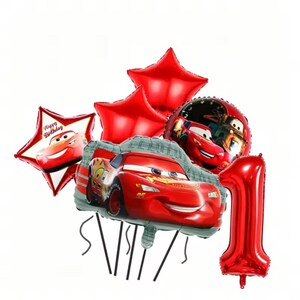 May include: A set of red foil balloons, including star-shaped and round balloons featuring Lightning McQueen from the Cars film. One balloon is shaped like the number 1. The star-shaped balloon has the text "Happy Birthday".