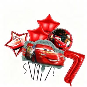 May include: A set of red foil balloons, including star-shaped and round balloons featuring Lightning McQueen from the Cars film. A large red number 7 balloon is also present, along with a balloon that says "Happy Birthday".